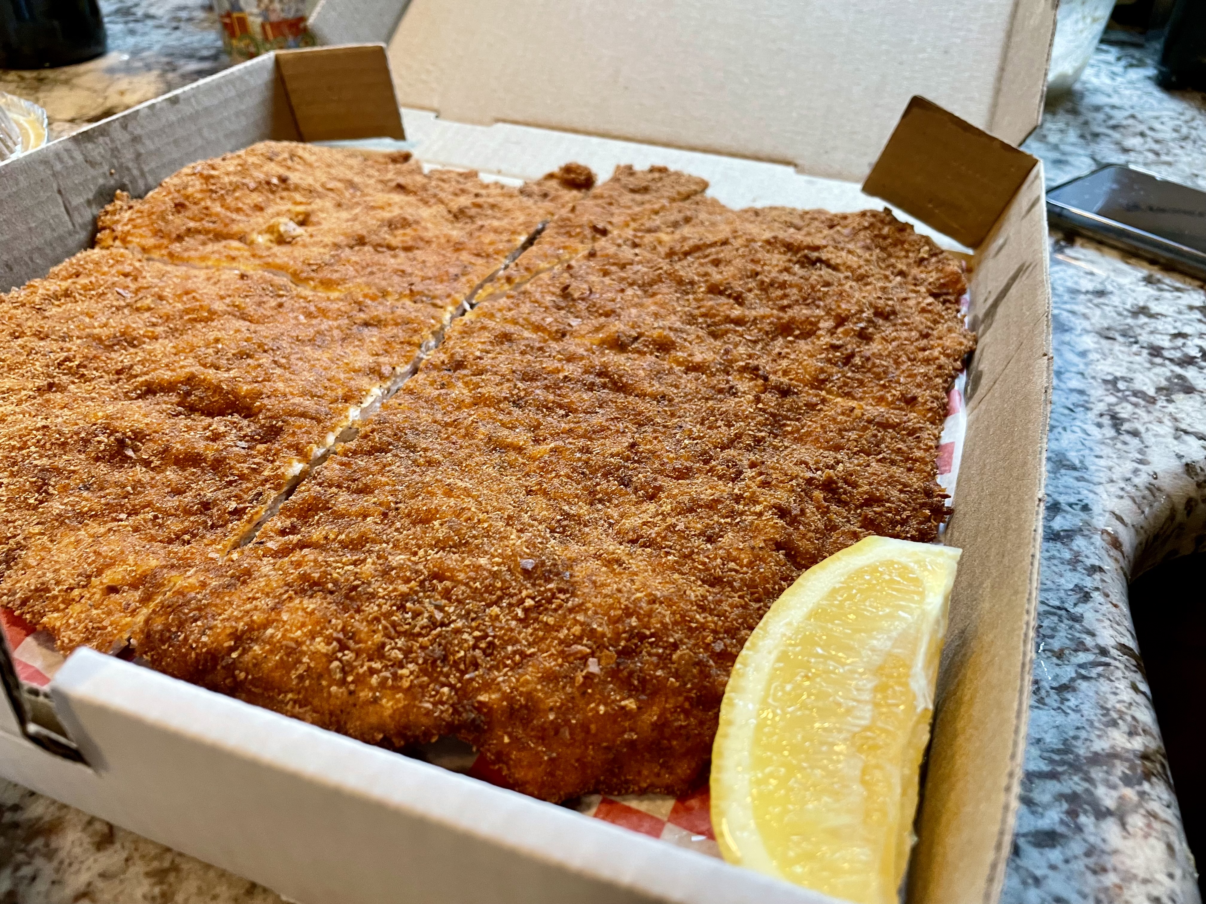 The pork schnitzel was packed into a pizza box and, despite the takeaway dinner, remained crispy throughout the meal