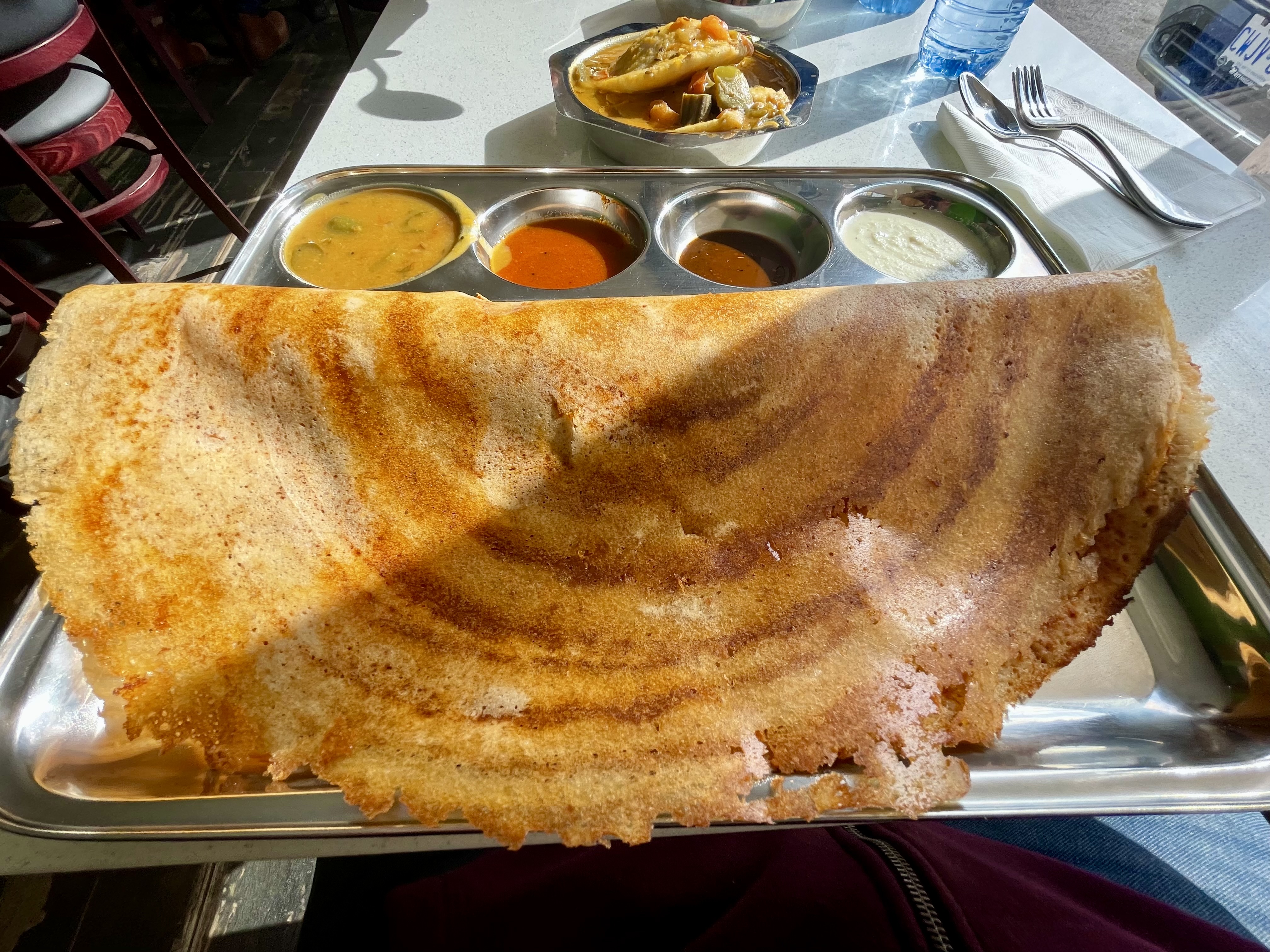 Dosa is made by soaking rice and lentils overnight in water and then grinding it into a batter, which is fermented overnight and then pan-roasted until crispy and served with potato curry, chutneys or sambar