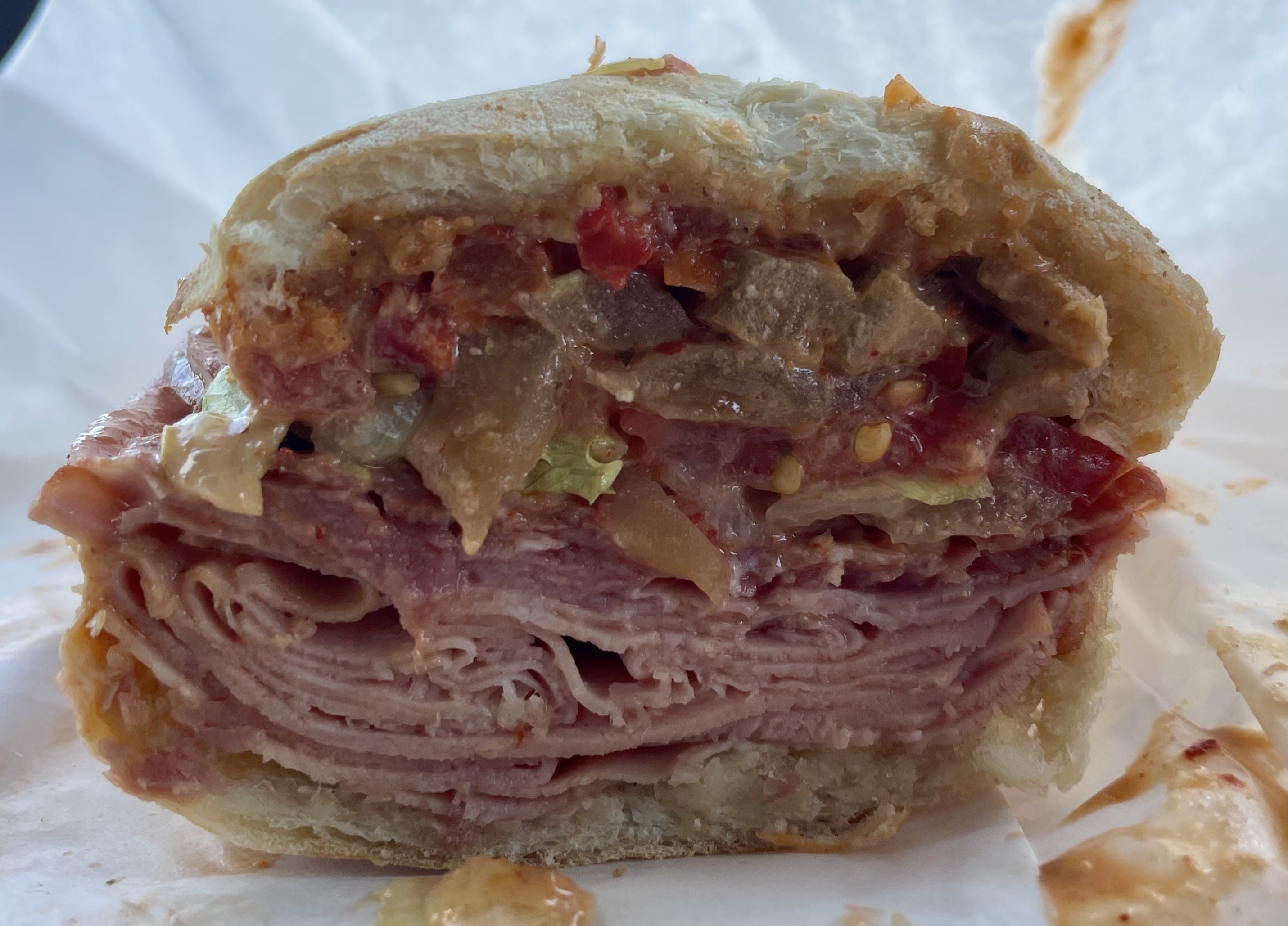With a generous portions of prosciutto, mortadella, capocollo, cheese, tomatoes, lettuce, roasted red peppers, pickled eggplant and chipotle, Roberto's Italian Trio is one of the most popular sandwiches on the menu