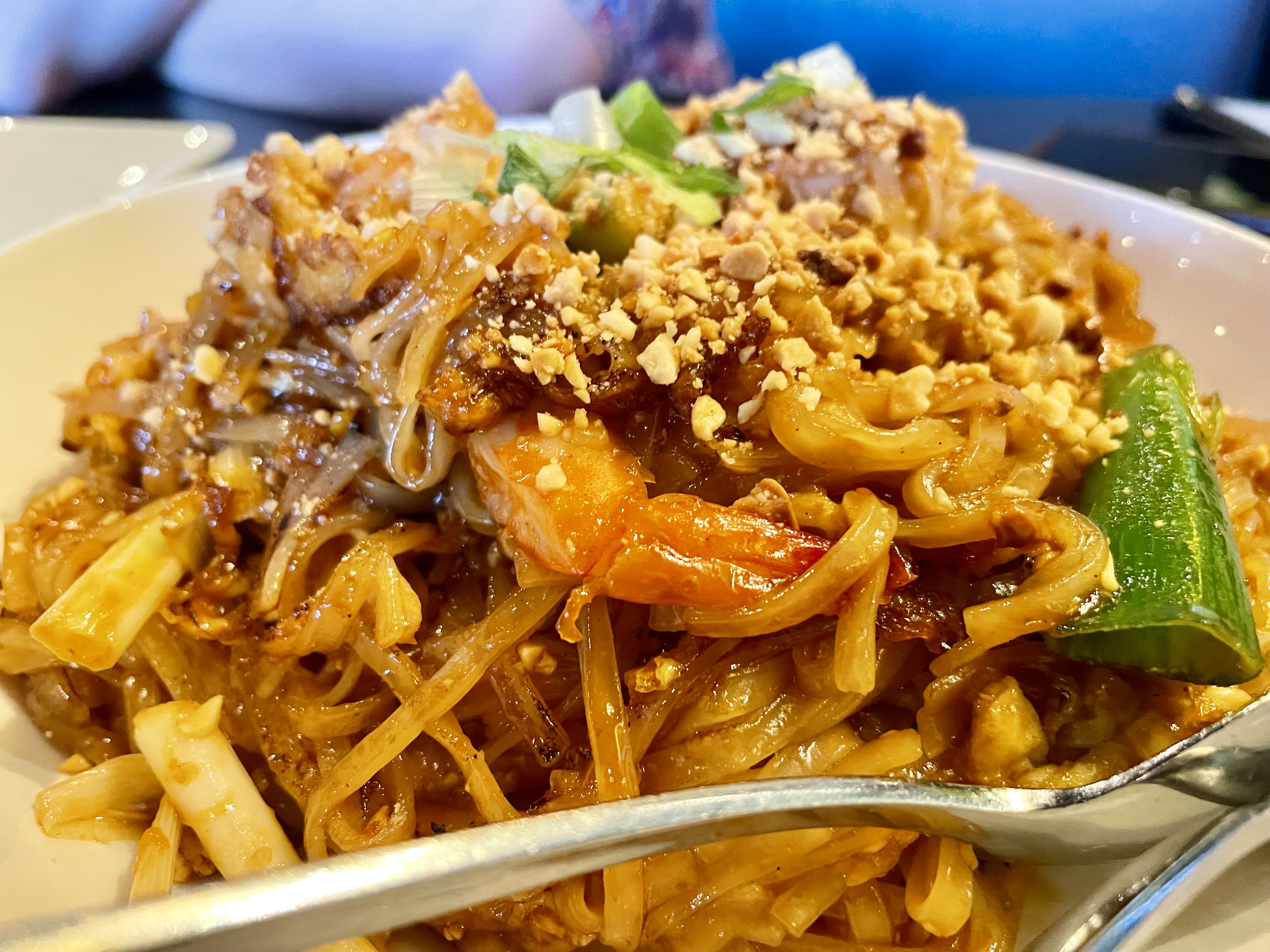 Pad thai is a rice noodle dish with stir-fried chicken, egg, bean sprouts, green onions and peanuts