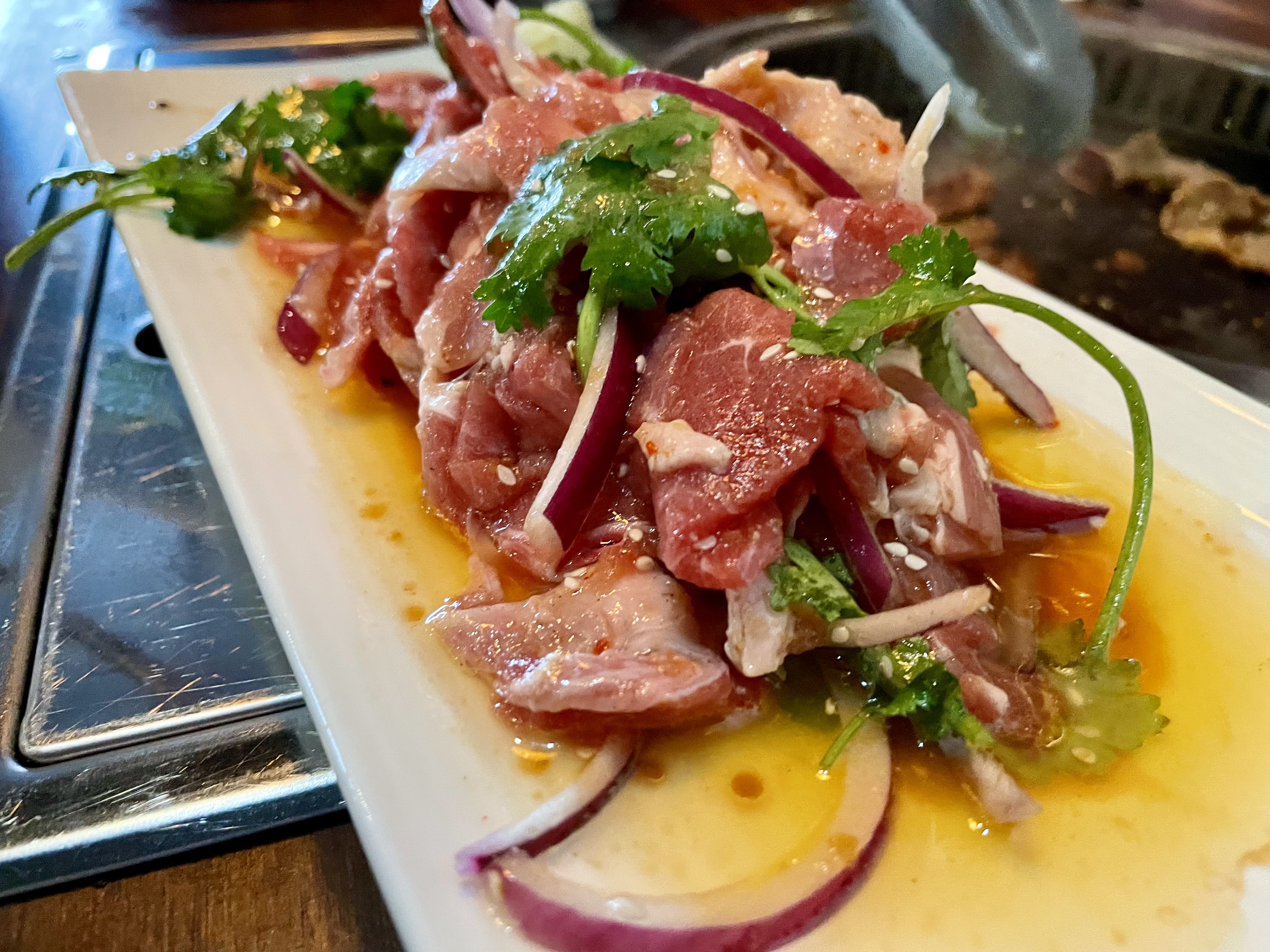 Thin strips of lamb were pre-marinated and served with onions, garlic, cilantro and peppers to barbecue at the table itself 