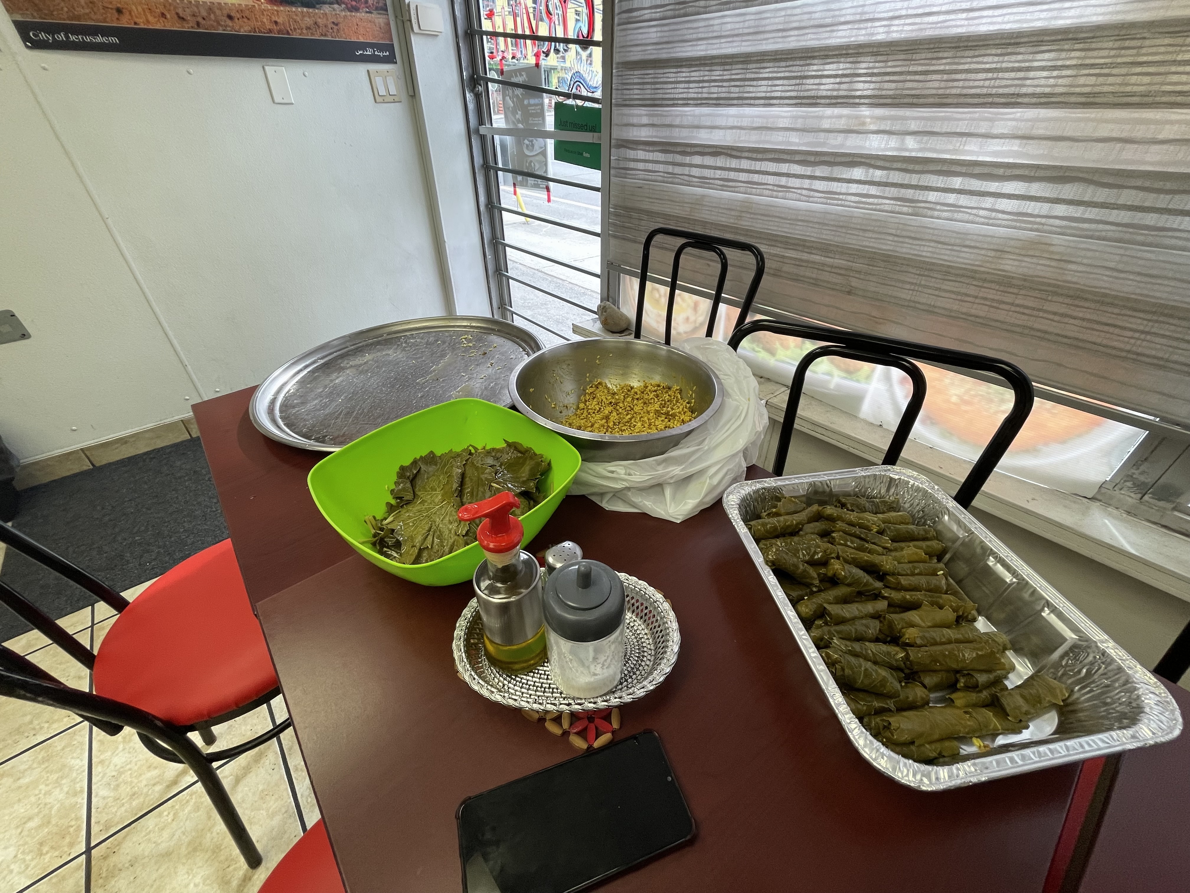 Ali's wife was busy preparing dawali, or Palestinian stuffed grape leaves, for a catering event
