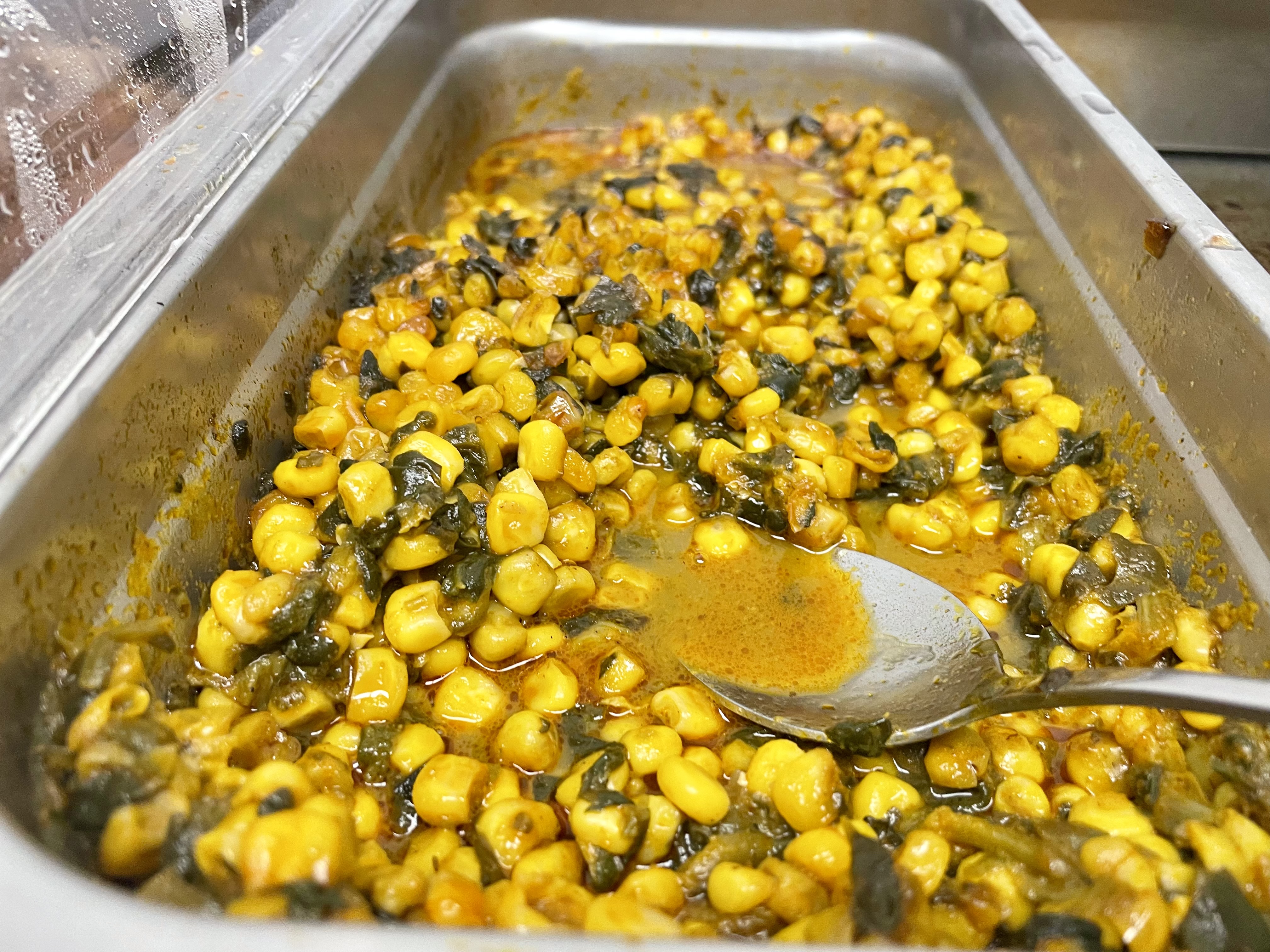 Pictured above is sangah, a popular Cameroonian dish made with corn, cassava leaf, and palm nut juice