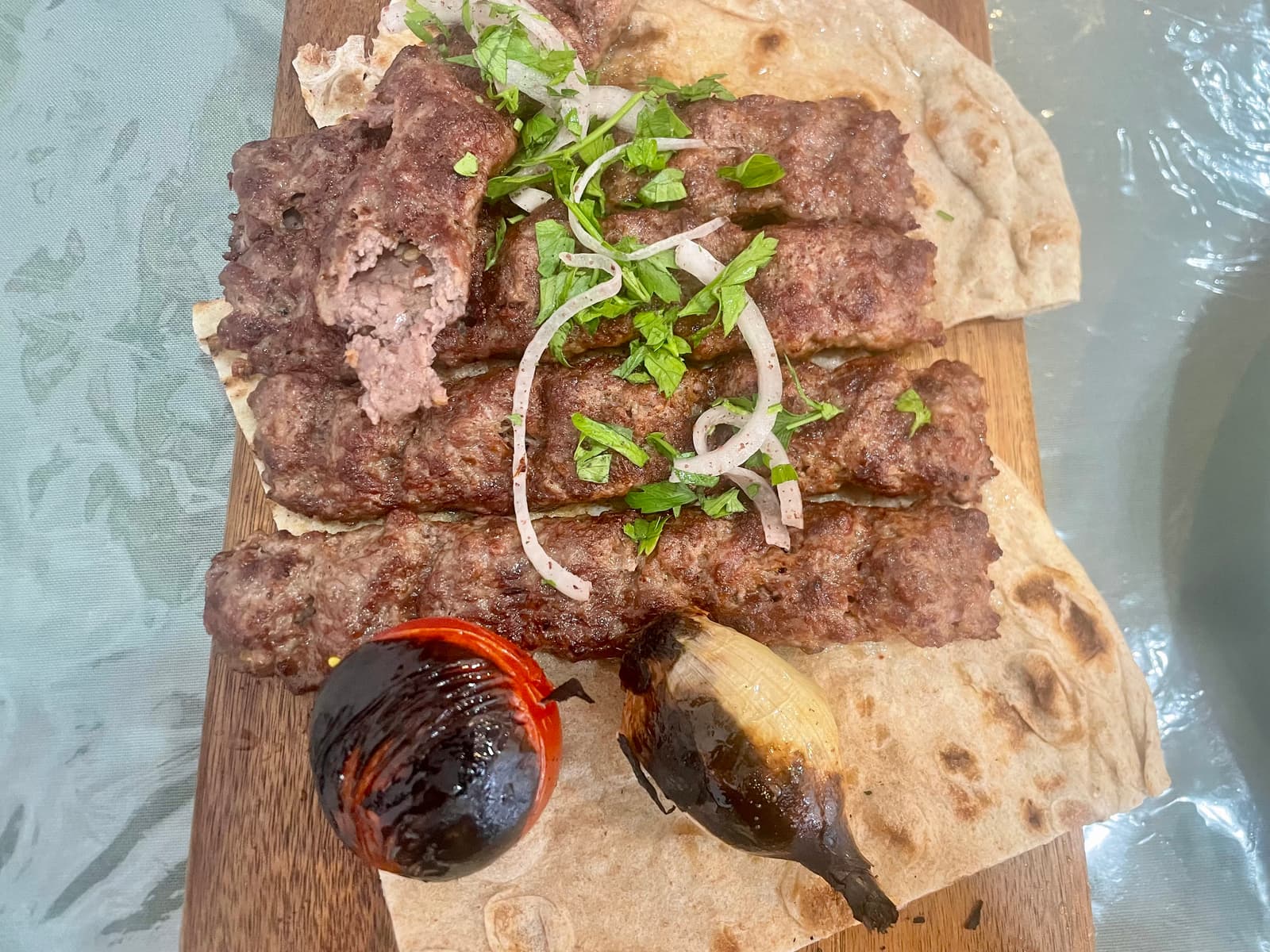 Lamb and beef kebabs, tandoor bread, hummus, mutabal, garlic, grilled onions and tomatoes, pickles and coleslaw made up one seriously generous Iraqi family feast