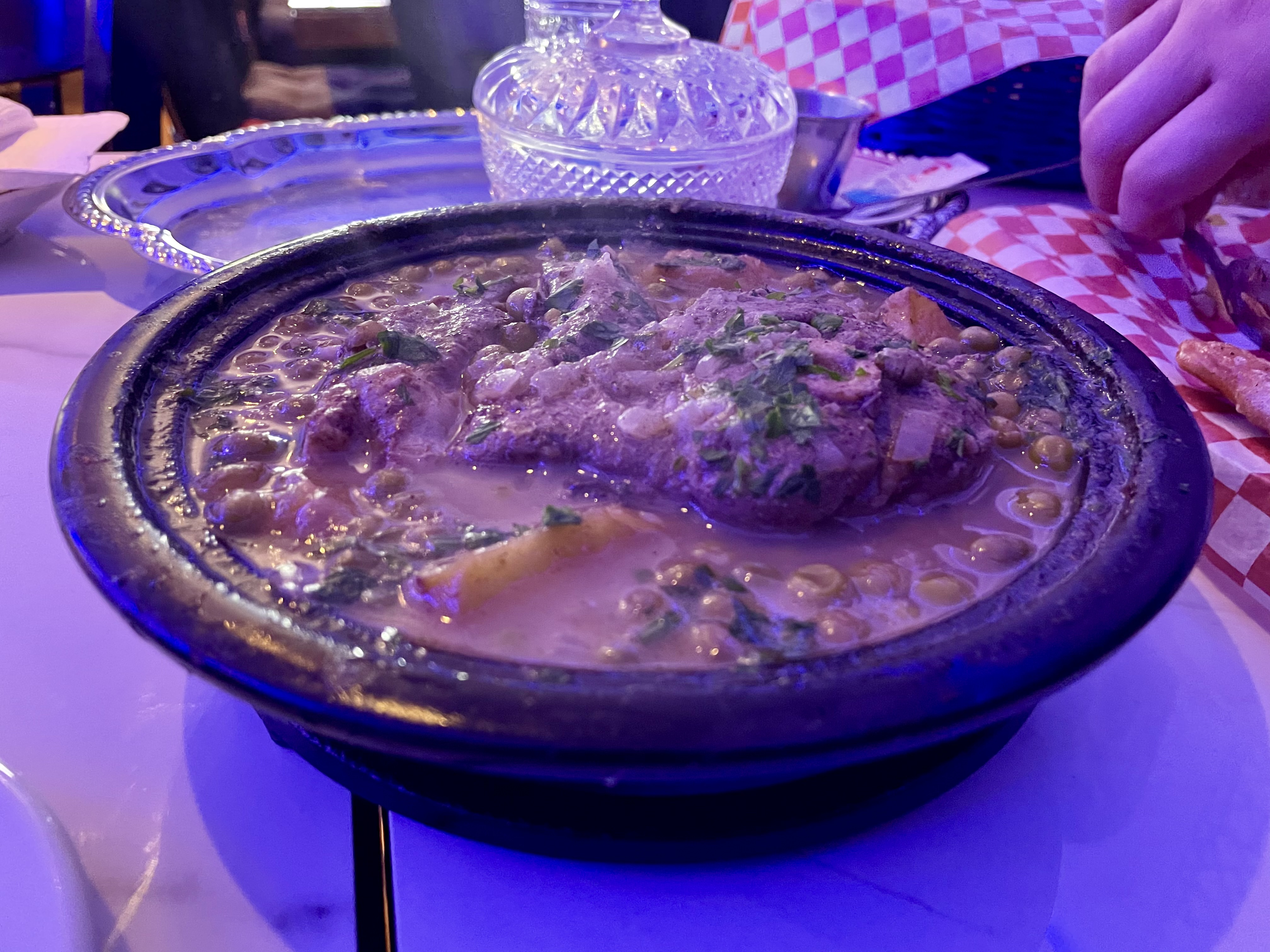The potato tajine is served with a rich sauce, succulent pieces of lamb green peas and, of course, potatoes