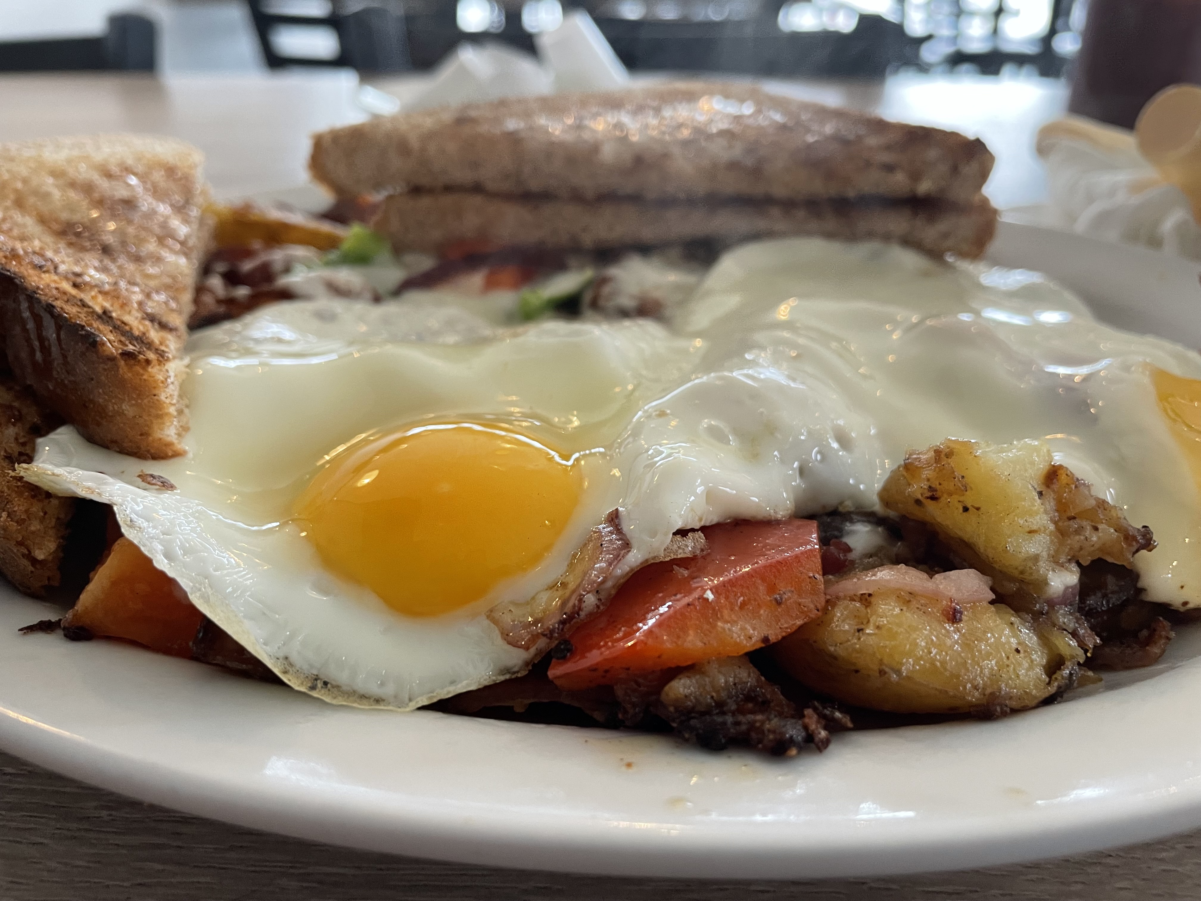 The breakfast hash came with a choice of two eggs, toast and homefries topped with bacon, sausage, green peppers, onions and cheese