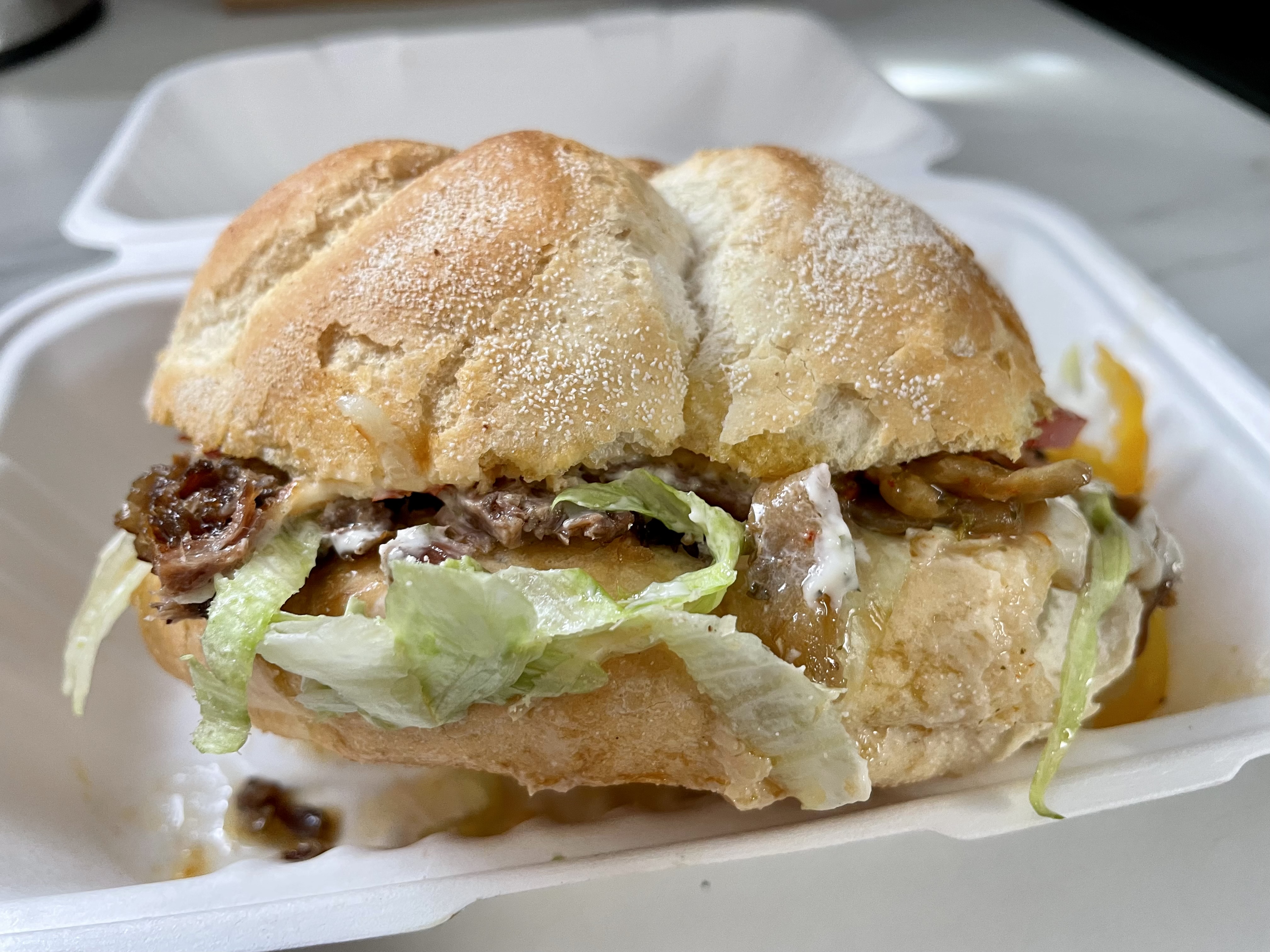 A behemoth of a sandwich that defies conventional lifting techniques, The Sandwich Stop's beef brisket creation combines tender house-cut meat with caramelized onions atop a sturdy Kaiser roll - a meal that doubles as both lunch and dinner