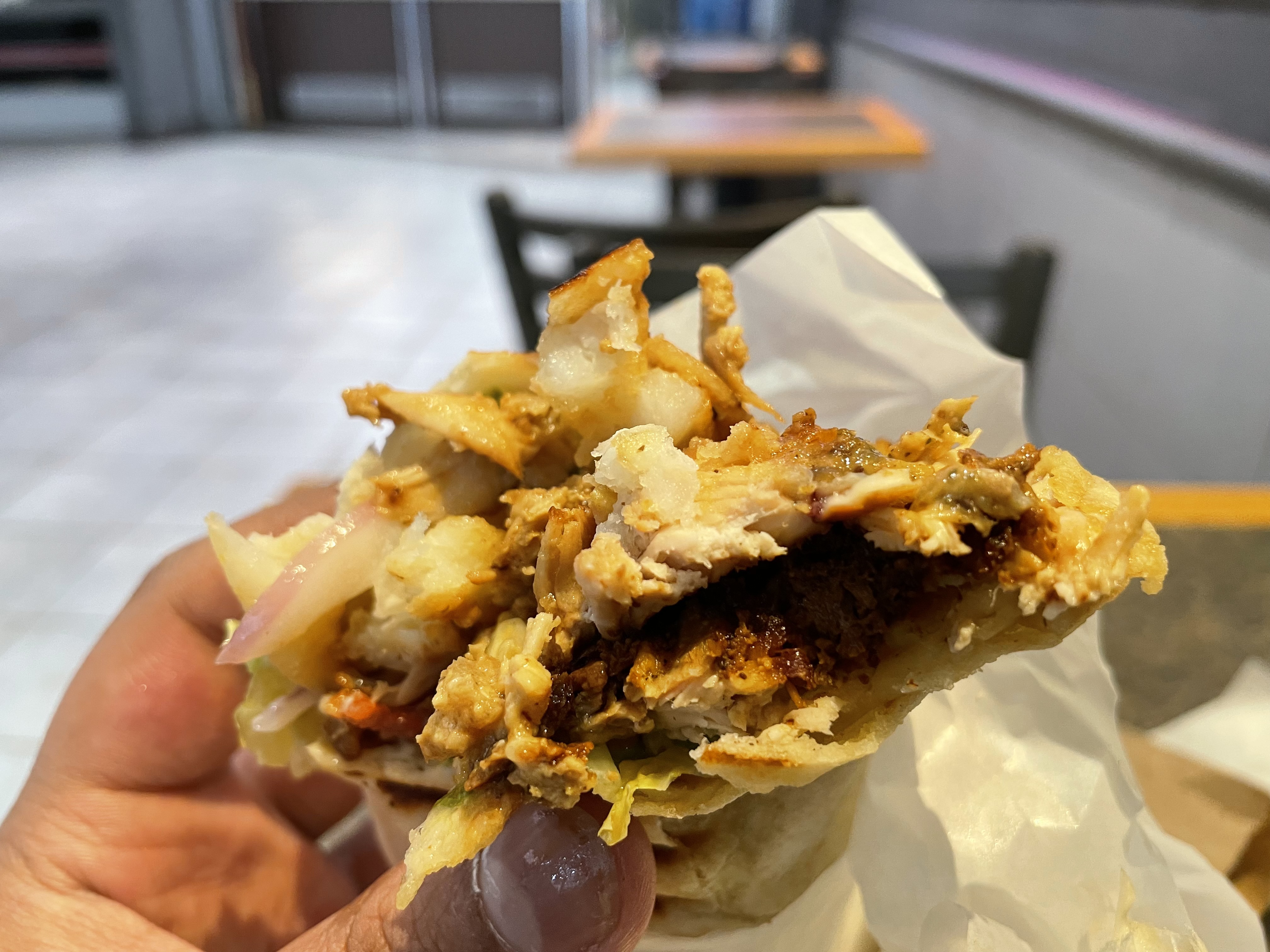  A piping-hot chicken shawarma, crispy on the outside, tender on the inside, with fries tucked in for that extra crunch.
