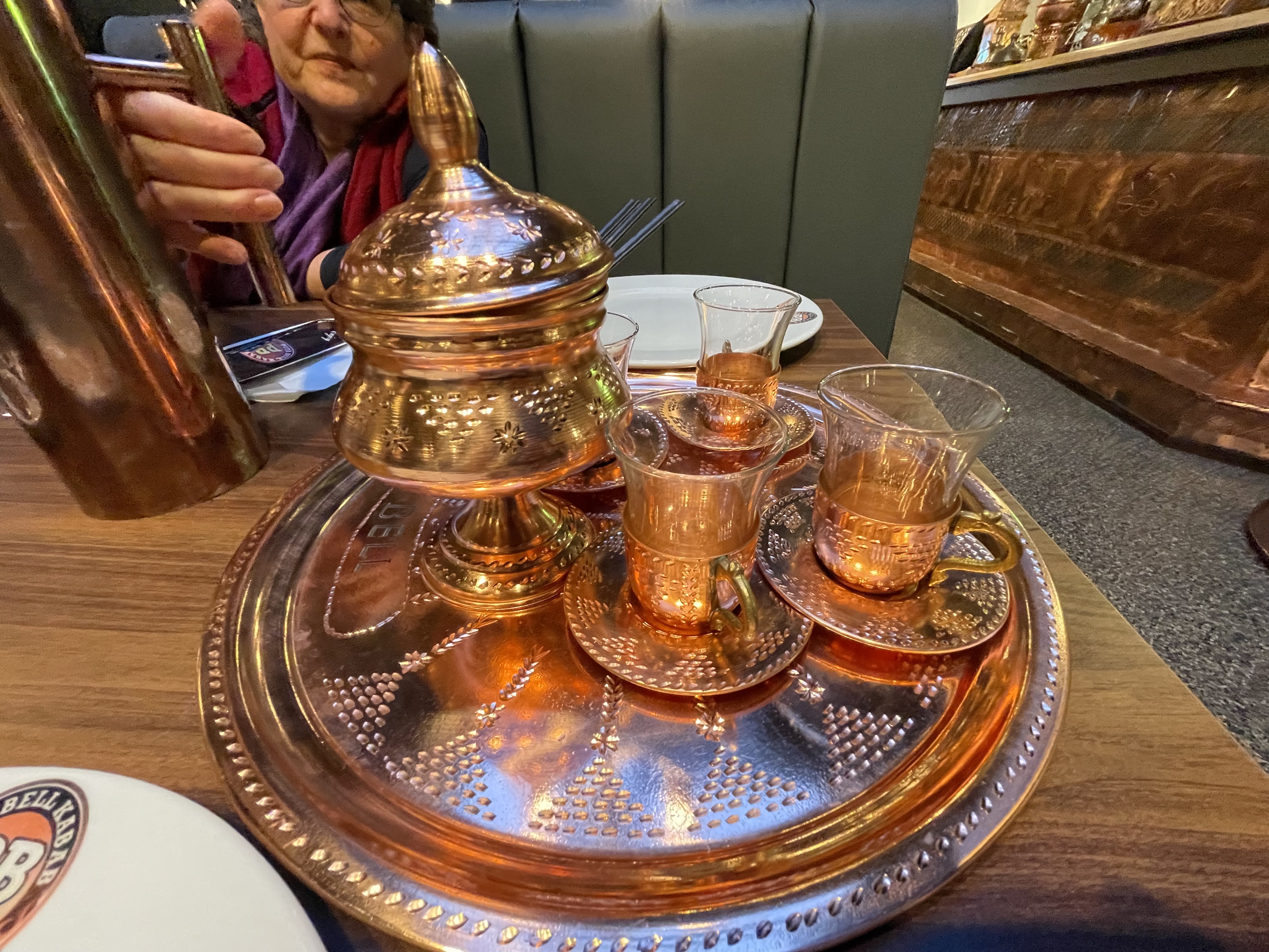 Turkish tea is typically prepared using two stacked teapots called "çaydanlık" specifically designed for tea preparation where water is brought to a boil in the larger lower teapot and then some of the water is used to fill the smaller teapot on top and steep several spoons of loose tea leaves, producing tea with a strong flavour