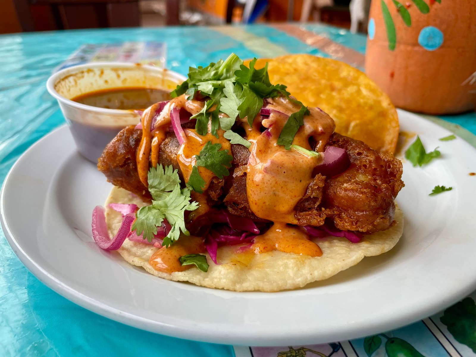 Brimming with slaw, sauce, and heat, the baja fish taco tastes like the kind of meal that makes you forget summer’s almost over