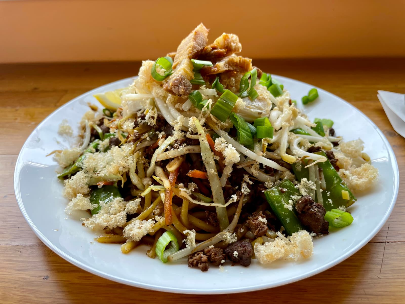 A heaping plate of pancit batil patung—egg noodles topped with pork belly, chicharrón, and a fried egg, straight from northern Philippines to Fredericton’s south side